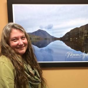 Maureen Dittmer pauses for a Kodak moment after hanging her show at Atlantic Motorcar. Courtesy of Alicia Howes Maureen Dittmer