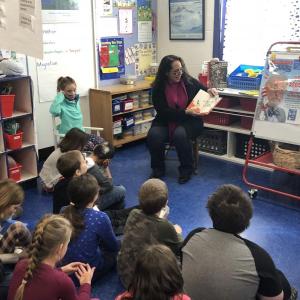 Larissa Darcy from Bar Harbor Bank and Trust shares a story with students in Wiscasset. Courtesy photo