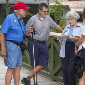 Volunteer B.J. Dobson, third from left, helps visitors find exhibits at Coastal Maine Botanical Gardens. Courtesy photo