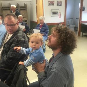 Steve Piwowarski, right, and son John, 1, meet with fellow Alna resident Jeff Spinney before selectmen’s May 30 meeting. SUSAN JOHNS/Wiscasset Newspaper