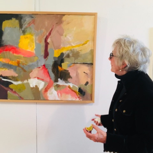 Daisy Greene of Damariscotta examines an abstract by Jorge Pena at the opening of the Maine Art Gallery’s Members Show June 1. Courtesy of the venue
