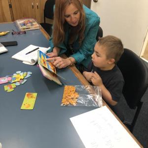 Wiscasset Superintendent of Schools Dr. Terry Wood reads to Pre-K student Timothy Robbins on May 30. Courtesy of Cindy Collamore