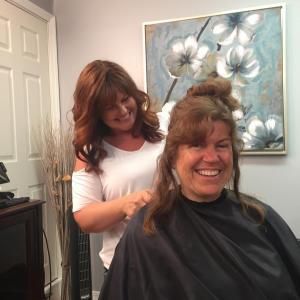 Possibilities Salon owner and Wiscasset School Committee member Desiree Bailey gives Wiscasset Middle High School librarian Cindy Carter a new look June 5, to benefit two causes. SUSAN JOHNS/Wiscasset Newspaper