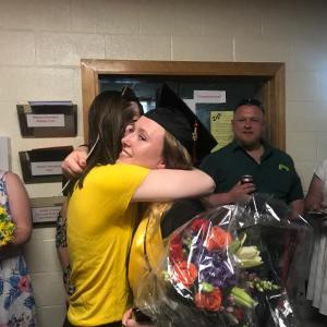 Sydnie Thayer gets a post-graduation hug from friend Grace Webber. SUSAN JOHNS/Wiscasset Newspaper