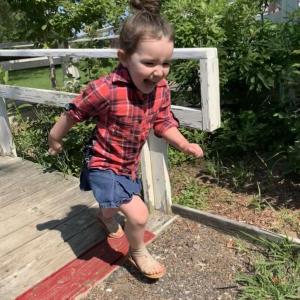 Allyson King, 4, runs off the old town office ramp in Alna Friday, two days after selectmen accepted her parents Jean Bradford and Alton King III’s offer on the 1800s cape. Looking on at top right is Allyson’s brother Mathew Pearson, 12. SUSAN JOHNS/Wiscasset Newspaper