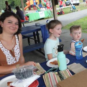 Roxana Branch and Jackie Branch, 6, of Boothbay Harbor, share a pizza picnic with Conrad Young, 3, of Boothbay Harbor, and his mother Valerie Young at last year’s “Night Out” in Wiscasset. File photo