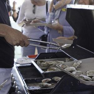 Charlie Herrick serving cooked oysters at a past Pemaquid Oyster Festival. Courtesy of Greg Latimer