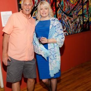 Ernie Gallerani and Michelle Wentworth pose before Abby Shahn’s massive triptych at the Maine Art Gallery opening reception for ‘Abstractions.’ Photo by Bob Bond
