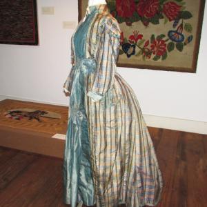 Silk gown in the style of the 1870s, displayed in the Hooked Rug Exhibit room; Chapman-Hall House collections. Courtesy of LCHA