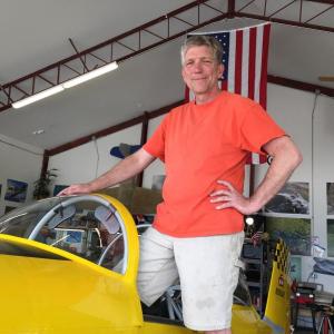 Longtime pilot Nick Knobil with his RV-8 plane, “The yellow peril” in his hangar at Wiscasset Municipal Airport July 14. SUSAN JOHNS/ Wiscasset Newspaper