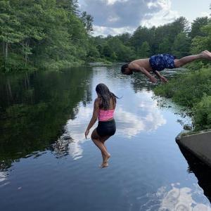 Wiscasset’s Anna Strozier, 12, jumps and father Ed Strozier dives into Nequasset Lake in Woolwich Sunday. Courtesy of Shelley Strozier