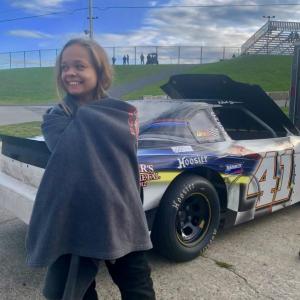 Before her four-cylinder race at Wiscasset Speedway Sept. 7, Buxton’s Nicole Benincasa, 16, bundles in a Portland Sea Dogs blanket. Meteorologist William Watson of National Weather Service’s Gray office said winds, clocked at 18 mph in Wiscasset earlier, were from former Category 5 Hurricane Dorian, which also pulled a cool air mass down from the north. At 5 p.m., less than an hour before Benincasa greeted Wiscasset Area Chamber of Commerce members in the pits, the Hurricane Center declared Dorian a post-tropical cyclone, Watson said. SUSAN JOHNS/Wiscasset Newspaper