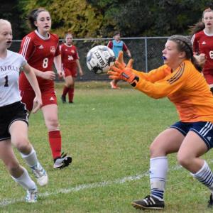 Wolverines goalie Lily Souza grabs a shot taken by Buckfield’s Madison Turcotte. That’s Kayla Cossette in close pursuit and Gwen Webber at far the right. PHIL DI VECE/Wiscasset Newspaper