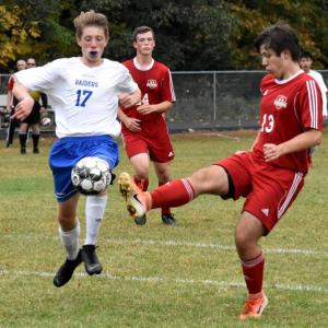 Wolverine Billy Pinkham goes up against Oak Hill’s Caleb Leighton. That’s Brian Foye in the background. PHIL DI VECE/Wiscasset Newspaper