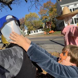Wiscasset’s Christopher Lincoln, 8, adjusts a scarecrow’s head at Scarecrowfest Oct. 19. SUSAN JOHNS/Wiscasset Newspaper