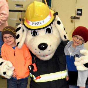 Camden Kelley, left, and brother Connor pose with Sparky the Fire Safety Dog. The boys’ dad David Kelley is a Woolwich firefighter and EMT. PHIL DI VECE/Wiscasset Newspaper