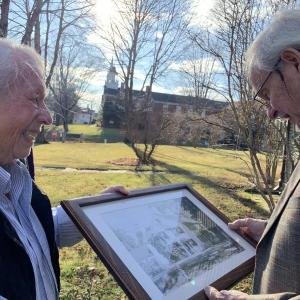 Perry Palmer hands a 20th century photo of William Dykes’ 1700s house to him Nov. 21 in Wiscasset. SUSAN JOHNS/Wiscasset Newspaper