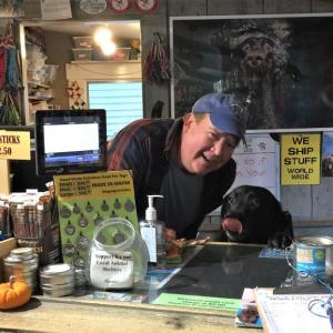 Two Salty Dogs co-owner Don Kingsbury, left, and Auggie guard the register while having a snack. JOSEPH CHARPENTIER/Boothbay Register