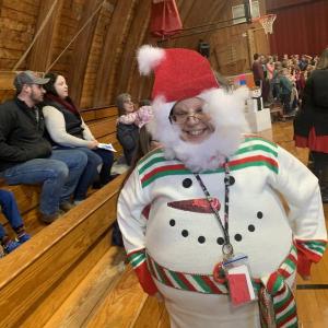 WES educational technician Jessica Bailey goes all out with festive wear at the Dec. 19 singalong in the gym. SUSAN JOHNS/Wiscasset Newspaper