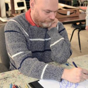 Lester Warman works on his next picture " What the man said” at Creative Expressions art group. See his work in the “Art From the Heart” show at Miles. Eleanor Busby photo