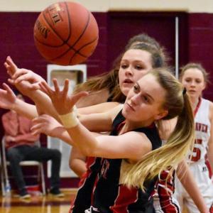 Wolverine Zoe Waltz and a Vinalhaven player scramble for a rebound Saturday. PHIL DI VECE/Wiscasset Newspaper