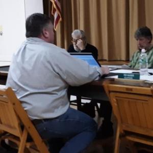 Bill Wentworth and David Hewins, left, of Central Maine Cost Recovery brief Edgecomb selectmen about its services. JANE CARPENTER/Boothbay Register