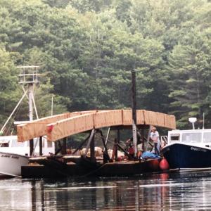 The beams for the pedestrian bridge at Ovens Mouth were floated on a barge from Wiscasset. The installation of the 93-foot bridge required careful planning and precise engineering. Courtesy of BRLT