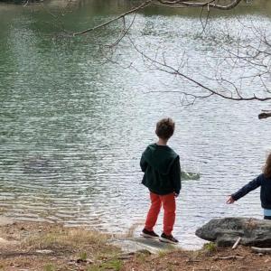 Two young visitors practice stone skipping on the shore at Oak Point Farm. Courtesy of BRLT