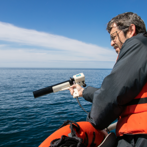 Senior Research Scientist Barney Balch collects ocean optics data during a research cruise in the Gulf of Maine. Balch is part of a team of researchers that has established a new approach to detect algae and measure key ocean properties using light, based on their research in the Gulf of Maine and beyond. Courtesy of Bigelow Laboratory for Ocean Sciences