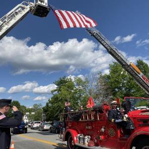 Hampden firefighter Oliver Bianchi salutes as the casket of Rich Kubler passes aboard a Bath fire truck on Route 1 after Saturday’s memorial service at First Congregational Church of Wiscasset. SUSAN JOHNS/Wiscasset Newspaper