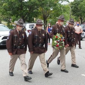 Lincoln County Sheriff Department’s honor guard presents a wreath Aug. 4 at a new courthouse monument honoring two law enforcement officers who lost their lives in service. BILL PEARSON/Boothbay Register