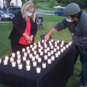 Addiction Outreach Specialist Holly Stover, left, and Harbor Peer & Wellness Center life coach Dylan Bredeau light candles Aug. 31 memorializing the 132 Mainers who died since June from drug overdoses. BILL PEARSON/Boothbay Register