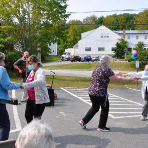 Kacie Gallant, Community Life director with resident, Jean Howe, and caregivers, Lois Burnham and Stephanie Gray, dancing to Orville Lee’s lively music. Kim Traina photo