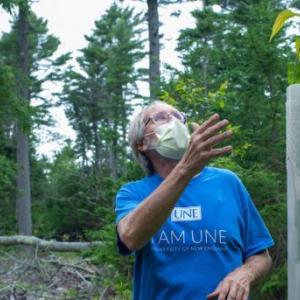 Tom Klak explains the significance of restoring the American chestnut.in the chestnut orchard at the Schoener Forest, near Georgetown. Courtesy of KELT