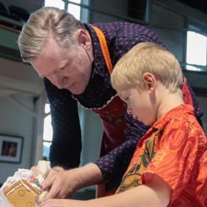 Kevin Kiley shows a gingerbread house architect the trade. Robert Mitchell photo