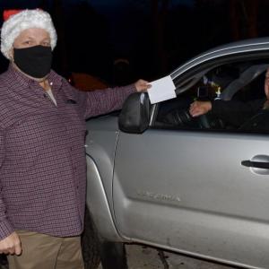 Selectman Jason Shaw accepts a ballot from his father Jack Shaw Saturday. PHIL DI VECE/Wiscasset Newspaper