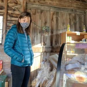 Morris Farm’s Food Security Coordinator Liza Goss views some baked goods donated Monday in a food drive at the free, take what you need food stand at the Gardiner Road, Wiscasset farm. SUSAN JOHNS/Wiscasset Newspaper