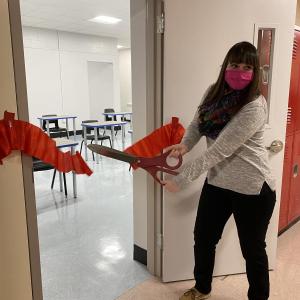 Liz Hemdal, who teaches health to all students grades 7-12, cuts the ribbon to her new classroom. Deb Pooler photo