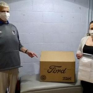 Warren Cossette, assistant principal and WMHS nurse Sommer Maybee greatly appreciated the donation of face masks manufactured by Ford Motor Co. PHIL DI VECE/Wiscasset Newspaper
