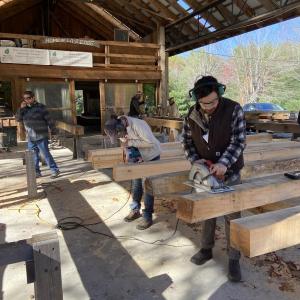 Beams lined up at the timber frame course. Courtesy of Midcoast Conservancy
