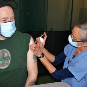 Mike Richardson of Wiscasset receives the COVID-19 vaccine from Angela Russ, RN, at the Boothbay Region Y Clinic Monday. Richardson was the 10,000th individual to receive a first dose at the clinic. Courtesy of LincolnHealth