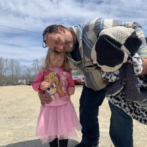 Returning Wiscasset Speedway fans John MacKenzie of Wiscasset and granddaughter Peyton Johnson, 3, wait in line for opening day April 24. SUSAN JOHNS/Wiscasset Newspaper