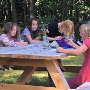 Young writers at work at the Merry Barn at a past summer camp. Courtesy photo