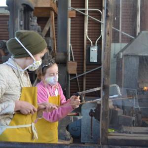Students work in the blacksmith shop at Maine Maritime Museum last fall. Crosscurrents, a new summer program, will give kids the opportunity to try traditional skills. Courtesy of Maine Maritime Museum.