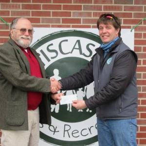 The new Chair, Joe Grant presenting Director Duane Goud with a check for $250 for the Kids Summer Camp program. Courtesy of the LCRC
