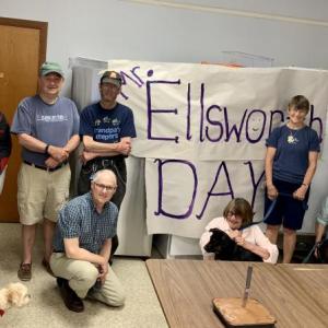 Standing, from left, inside St. Philip’s Episcopal Church June 14 are Help Yourself Shelf volunteer Kristen Haines with a neighbor’s dog, fellow volunteers Susan Ratigan and Deane Atwood, the guest of honor Ellsworth Stone and volunteers Sharman Ballantine and Joni Leigh. On the floor, from left, are volunteers Tom Junkert and Deborah Morgan, with volunteer Gretchen Burleigh-Johnson’s dog Bo, and Burleigh-Johnson with her dog Pippa. SUSAN JOHNS/Wiscasset Newspaper