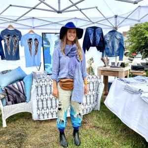 Boothbay native Morgan Mitchell shows off handpainted shirts and jackets at the 59th Windjammer Days’ Artists’ Alley. ISABELLE CURTIS//Boothbay Register