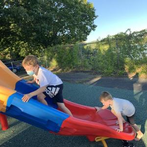 Corben Jones, 6, left, and brother Paxton, 4, use the slide during Wiscasset Elementary School’s outdoor open house Sept. 16. SUSAN JOHNS/Wiscasset Newspaper