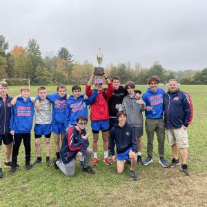 The Seahawks-Wolverines boys team hold up their MVC’s first place trophy. Courtesy photo