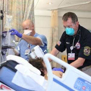 U.S. Department of Health and Human Services DMAT (Disaster Medical Assistance Team) members treat a patient at Maine Medical Center (December 2021). Courtesy of MMC